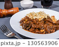 Delicious hungarian goulash with spaetzle served on white plate 130563906
