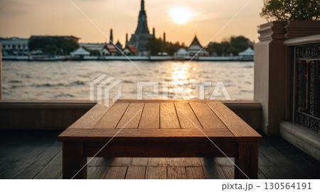Wooden table balcony view of Wat Arun temple by Chao Phraya River at sunset Bangkok 130564191