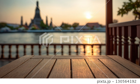 Wooden table balcony view of Wat Arun temple by Chao Phraya River at sunset Bangkok 130564192