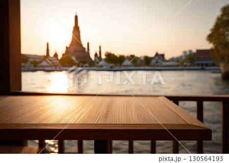 Wooden table balcony view of Wat Arun temple by Chao Phraya River at sunset Bangkok 130564193