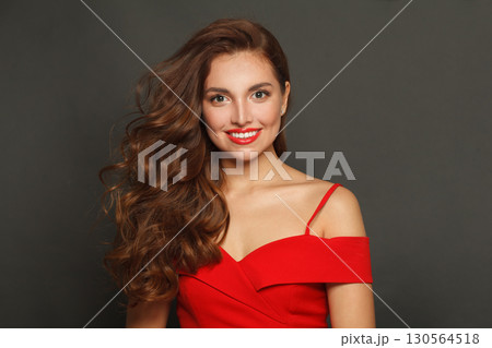 Fashionable brunette woman with trendy make-up and brown curly hair wavy hairstyle Fashionable brunette woman with trendy make-up and brown curly hair wavy hairstyle 130564518