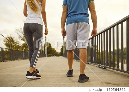 Close-Up Of Man And Woman Jogging In City Park 130564861