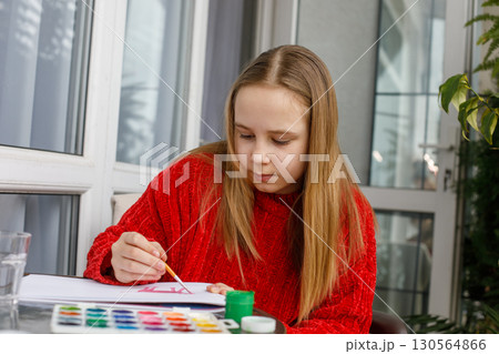 Cheerful kid drawing. Cute child at home Cheerful kid drawing. Cute child at home 130564866