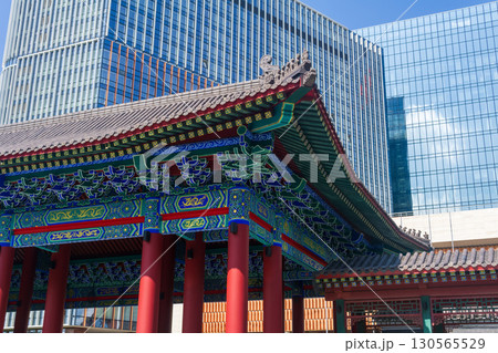 Chinese traditional architecture on a background of a modern skyscrapers in Chinese business center Park Huaming Chinese traditional architecture on a background of a modern skyscrapers in Chinese business center Park Huaming 130565529