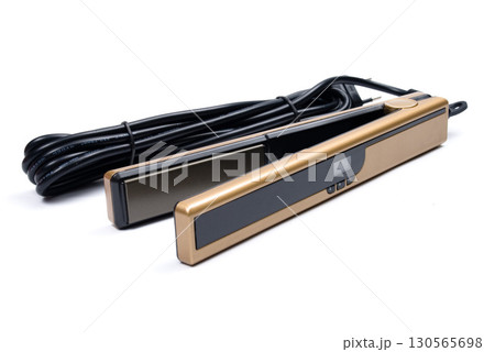 Gold eletronic hair iron straightener on white background 130565698