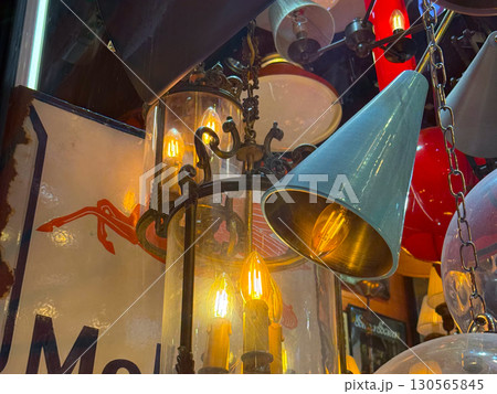 Vintage lamps and chandeliers with warm glowing bulbs. Retro design, nostalgia, and cozy ambiance. Vintage lamps and chandeliers with warm glowing bulbs. Retro design, nostalgia, and cozy ambiance. 130565845