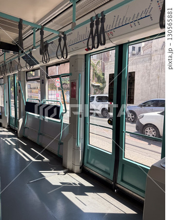Interior of modern tram with doors and handles. Public transport, travel, and city mobility. Interior of modern tram with doors and handles. Public transport, travel, and city mobility. 130565881