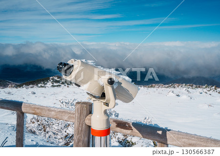 Frosted binocular viewer overlooking winter landscape on Hallasan, Jeju 130566387