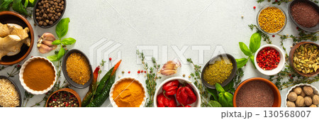 Colorful, fresh herbs and spices framing a gray background, a perfect natural border to bring attention to culinary creativity, top view and copy space, banner 130568007