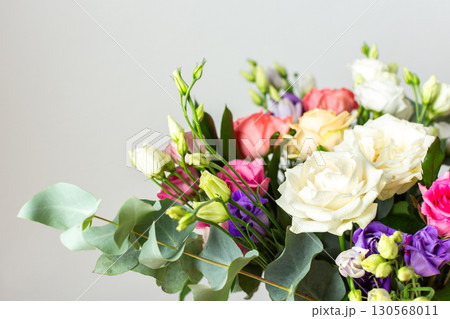 Celebrate special occasions with a colorful summer bouquet featuring fresh roses, eucalyptus, and eustoma blooms, creating an elegant and fragrant floral arrangement Celebrate special occasions with a colorful summer bouquet featuring fresh roses, eucalyptus, and eustoma blooms, creating an elegant and fragrant floral arrangement 130568011