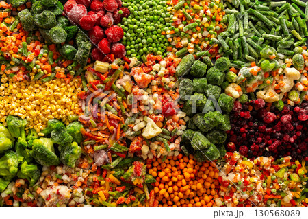 A vivid display of frozen fruits and vegetables in a colorful arrangement, illustrating the process of preserving healthy, seasonal produce for winter, promoting a healthy diet 130568089