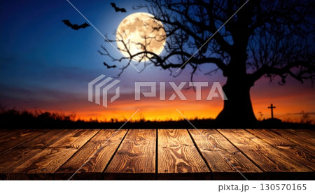 An eerie Halloween night with a silhouette of trees against an orange sky and a full moon An eerie Halloween night with a silhouette of trees against an orange sky and a full moon 130570165