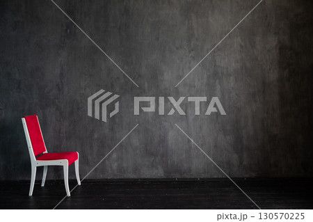 Pink chair in the interior of an empty dark gray room Pink chair in the interior of an empty dark gray room 130570225