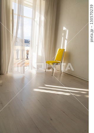 yellow vintage wall chair in an empty room 130570239