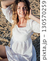Outdoors portrait of beautiful young girl laughing 130570259