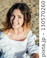 Outdoors portrait of beautiful young girl laughing 130570260