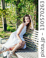 Outdoors portrait of beautiful young girl laughing 130570263