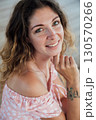 woman smiling in light summer dress outdoors 130570266