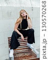 Portrait of a beautiful young woman in a black suit 130570268