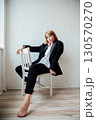 Portrait of a beautiful young woman in a black suit 130570270