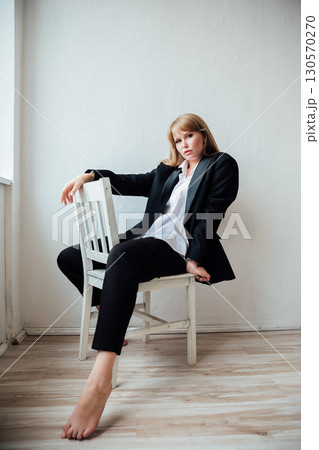 Portrait of a beautiful young woman in a black suit Portrait of a beautiful young woman in a black suit 130570270