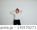 Portrait of a happy woman with closed eyes over gray background 130570271