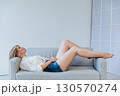 Pretty young female with big smile standing at bedroom after work with laptop and having fun taking light cheerful selfie 130570274