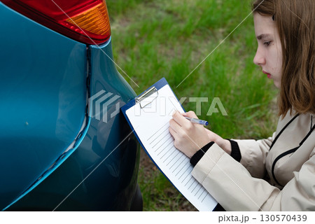 Insurance agent draws up documents after accident. Services of insurance companies concept 130570439