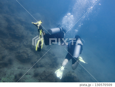 A man and a woman diving underwater on a coral reef in the South China Sea in Vietnam A man and a woman diving underwater on a coral reef in the South China Sea in Vietnam 130570509