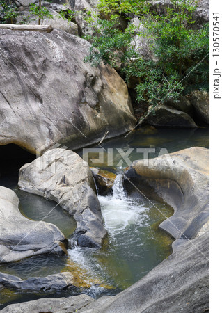 Huge rocks in a mountain river in a tropical forest in Vietnam Huge rocks in a mountain river in a tropical forest in Vietnam 130570541