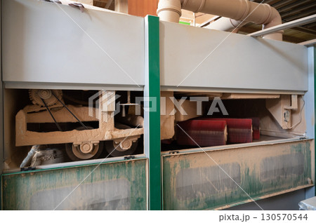 Grinding of wooden furniture panels on a machine 130570544