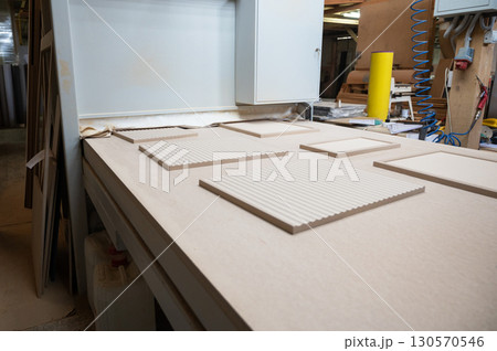 Grinding of wooden furniture panels on a machine Grinding of wooden furniture panels on a machine 130570546