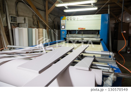 Grinding of wooden furniture panels on a machine 130570549