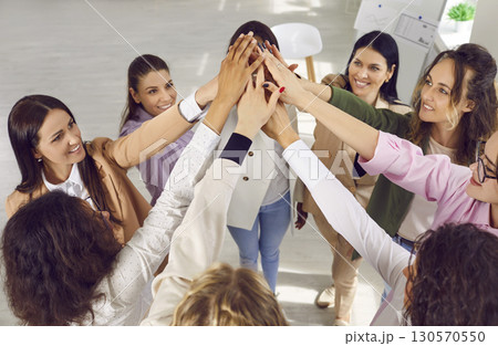 Group of smiling young women doing high five gesture 130570550