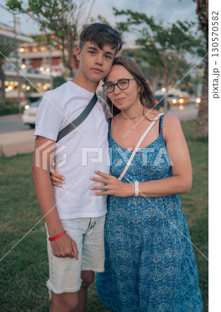 Happy family mom and her teen son on a beach Happy family mom and her teen son on a beach 130570582