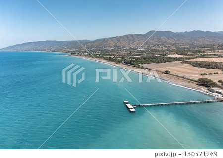 Aerial view of Polis coastline featuring a long pier stretching into the Mediterranean Sea, Cyprus 130571269
