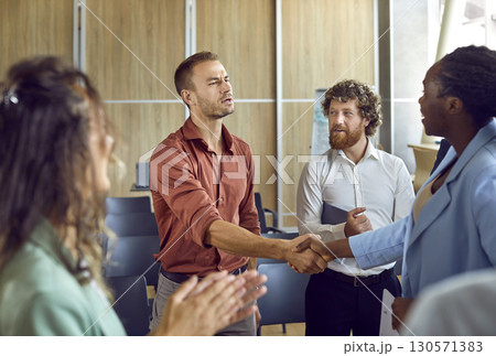 Business people standing in office making deal or signing contract on meeting. Business people standing in office making deal or signing contract on meeting. 130571383