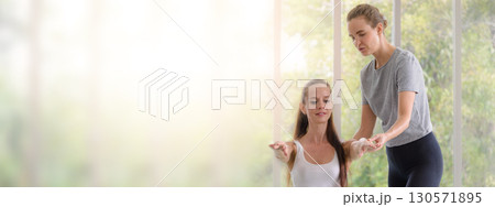 Caucasian woman sitting and balancing with trainer. fitness, sport, training and people concept. Banner cover design. Caucasian woman sitting and balancing with trainer. fitness, sport, training and people concept. Banner cover design. 130571895