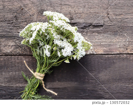 Yarrow flower herbal plants on wooden table. Top view Yarrow flower herbal plants on wooden table. Top view 130572032