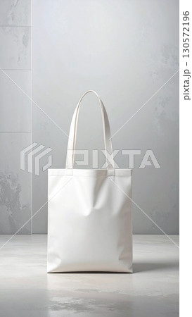Minimalist White Tote Bag on Gray Mottled Surface in Soft Studio Lighting 130572196