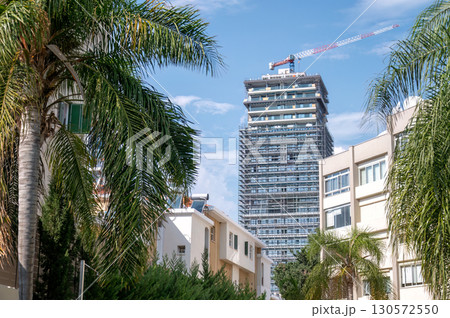 Construction site of modern skyscraper rising above Limassol cityscape in Cyprus 130572550