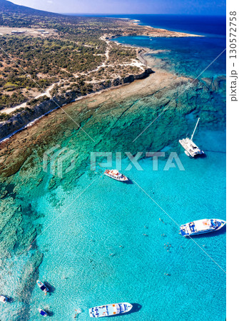 Aerial view of tourists swimming and enjoying the turquoise waters of Chrysochou bay in the blue lagoon, Akamas peninsula, Cyprus 130572758