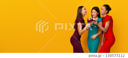 Three Diverse Girls Having Fun On A Party Holding Red Wine Glasses Talking And Laughing Over Yellow Studio Background. Panorama Three Diverse Girls Having Fun On A Party Holding Red Wine Glasses Talking And Laughing Over Yellow Studio Background. Panorama 130573112
