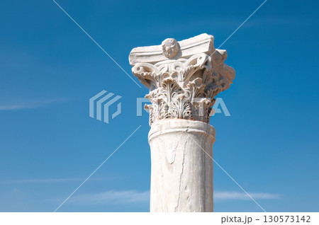Weathered corinthian column standing against azure sky, revealing architectural legacy of Kourion archaeological site in Cyprus Weathered corinthian column standing against azure sky, revealing architectural legacy of Kourion archaeological site in Cyprus 130573142