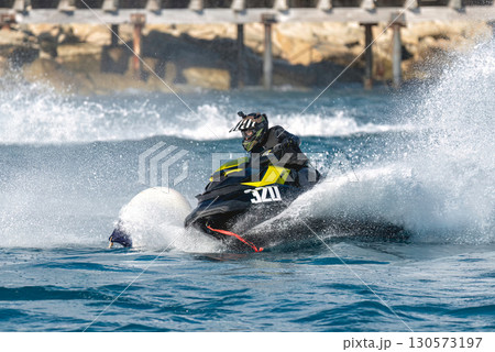 Professional athlete riding a water scooter in a race on the sea 130573197