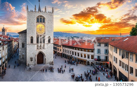 Romanesque Clock Tower Dominates Lively Square at Sunset, Embrun 130573296