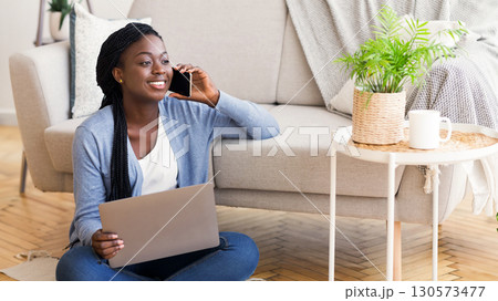 Freelance Career. Guy Talking On Cellphone Using Laptop Sitting On Floor At Home. Free Space For Text Freelance Career. Guy Talking On Cellphone Using Laptop Sitting On Floor At Home. Free Space For Text 130573477