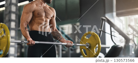 Powerlifting. Muscular guy lifting heavy barbell at gym, panorama with copy space Powerlifting. Muscular guy lifting heavy barbell at gym, panorama with copy space 130573566