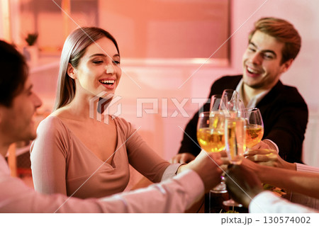 Christmas Corporate Party. Happy Coworkers Clinking Glasses Toasting During Xmas Celebratory Dinner Sitting In Restaurant. Selective Focus 130574002