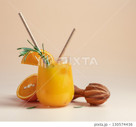 Orange juice and wooden squeezer. 130574436